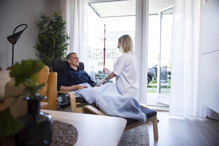 Bilde av kreftpasient Sigurd Solheim og sykepleier i leilighet