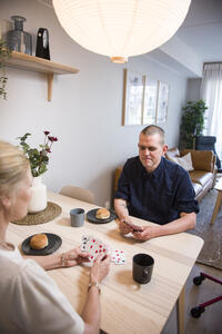 Bilde av Sigurd Solheim og sykepleier som spiller kort